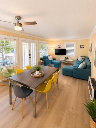 a living room with a table and chairs at CasaViva Sky - 3BR 1BA Sleeps 10 - Rooftop City Views, Firepit & Bunk Room - Near Zoo & Beaches in San Diego