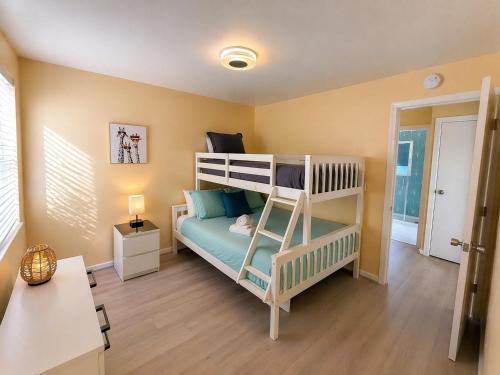 a bedroom with a bunk bed with a ladder at CasaViva Sky - 3BR 1BA Sleeps 10 - Rooftop City Views, Firepit & Bunk Room - Near Zoo & Beaches in San Diego