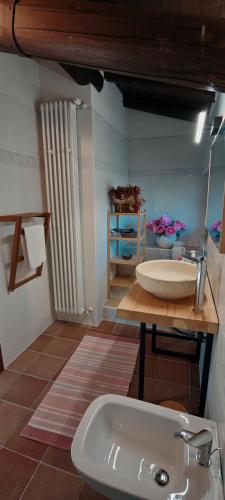 a bathroom with a sink and a table at Cascina Silene in Castelmarte