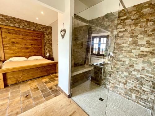 a bedroom with a bed and a glass shower at “La Casetta nel Borgo” in Cerveteri