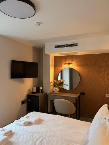 a hotel room with a bed and a mirror at Vip Stay in Gotse Delchev