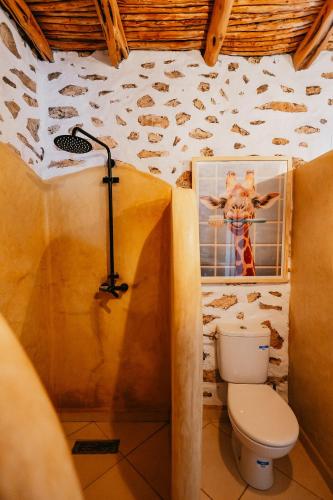 a bathroom with a toilet and a picture of a giraffe at Surf HouseMaroc in Essaouira