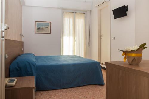 a hotel room with a blue bed in a room at Hotel Nello in Marina di Andora