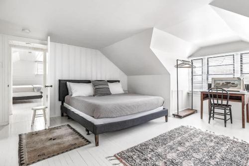 a bedroom with a bed and a table and a desk at Hygge House in Harbert