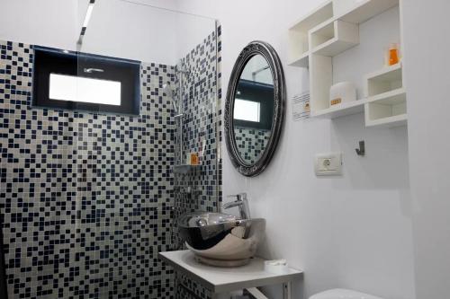a bathroom with a sink and a mirror in it at Solemar Boutique in Eforie Sud