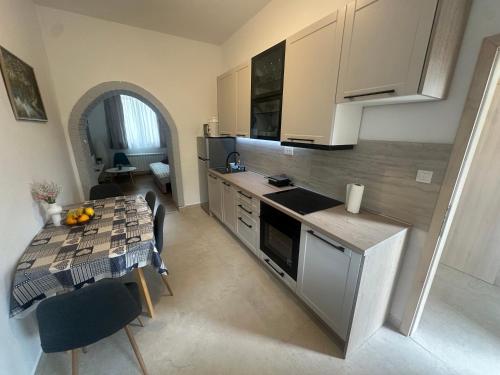 a kitchen with a table and a counter top at Crystal Lakes Apartment in Plitvička Jezera