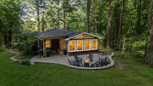 a tiny house in the woods with a fire pit at Wonderwood Cottage in Sawyer