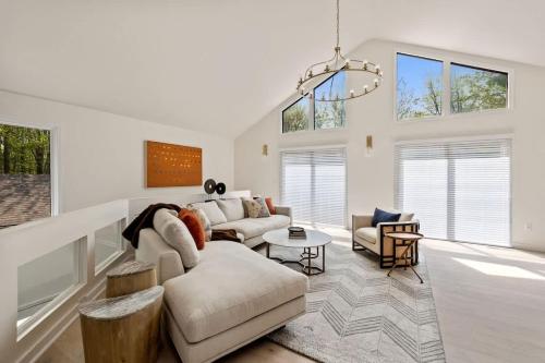 a living room with a couch and a table at The Coyote by Juniper Holiday + Home in Saugatuck