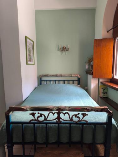 a bedroom with a bed with a blue comforter at Ξενώνας Μυρτώ in Andritsaina