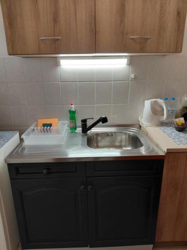a kitchen counter with a sink in a kitchen at Студиа Мансарда Ненови in Pomorie