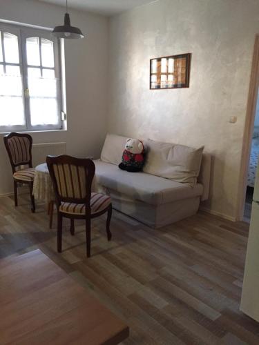 a living room with a couch and two chairs at Viktória Inn Tihany in Tihany
