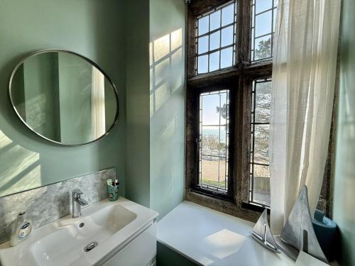 a bathroom with a sink and a mirror at 4 Coram Tower in Lyme Regis