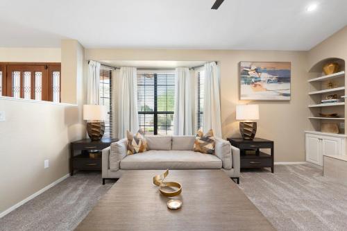 a living room with a couch and a table at Glendale Paradise - Pool - Pickleball - Putt-Putt in Glendale