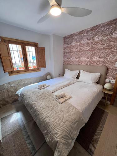 a bedroom with a large bed with two towels on it at Mi Casa 4 in Jávea