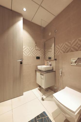 a bathroom with a sink and a toilet at Town Centers in Ghaziabad