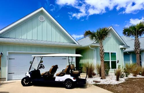 a golf cart parked in front of a house at Windmark-Beach Therapy in Port Saint Joe