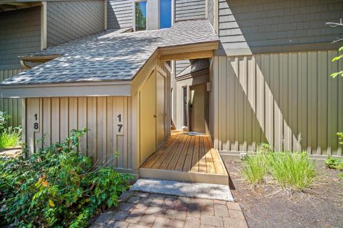 a house with a wooden walkway leading to the front door at 17 Quelah Condo in Sunriver