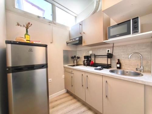 a kitchen with a stainless steel refrigerator and a sink at Mistral Studio in Cassis