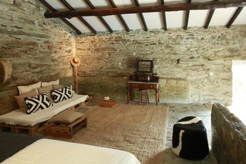 a living room with a couch and a table at CASA da PISCINA, Quinta do Espinho, Douro Valley in Tabuaço
