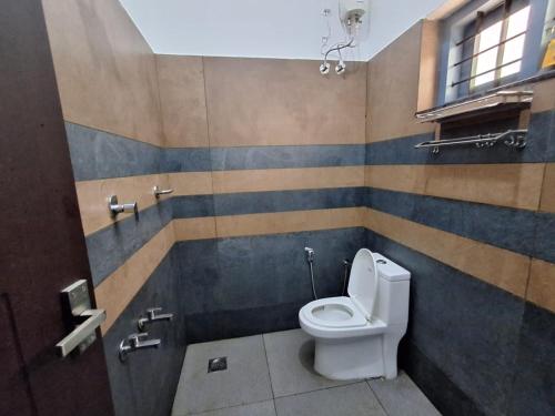 a bathroom with a white toilet in a stall at Private Pool Villa Vagamon in Vagamon