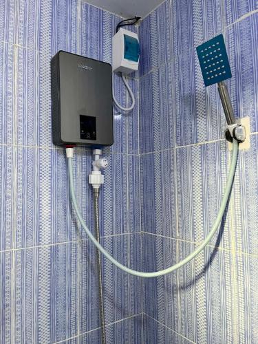 a wall with a tv and a charger on a wall at Log Horizon by The Guild Oasis Transient House in Rosario
