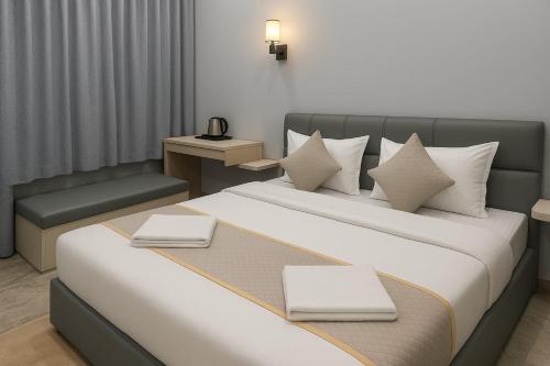 a hotel room with two beds and a chair at The Aura - Backpacker Stop in Nainital