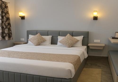 a bedroom with a large bed with two pillows at The Aura - Backpacker Stop in Nainital