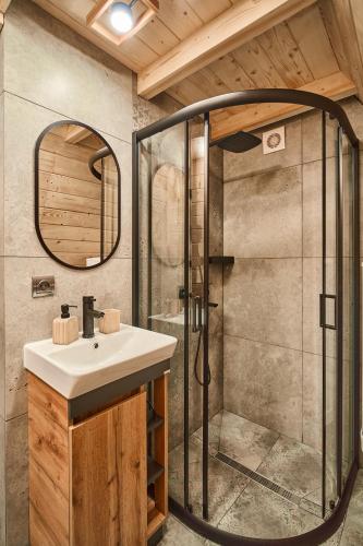 a bathroom with a sink and a shower at ULISI house in Verkhniy Yasenov