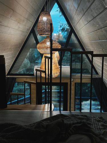 a room with a large window with a lamp at ULISI house in Verkhniy Yasenov