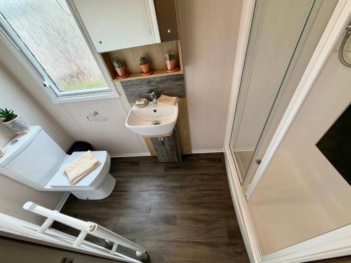 a small bathroom with a sink and a toilet at Rosies by the Sea in Walton-on-the-Naze