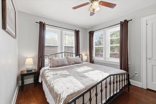 a bedroom with a bed and a ceiling fan at Waldo Craftsman - Fenced yard Walkable to dining in Kansas City