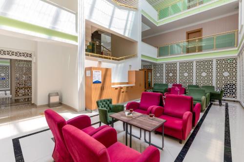 a waiting room with pink chairs and a table at The Suites in Antalya