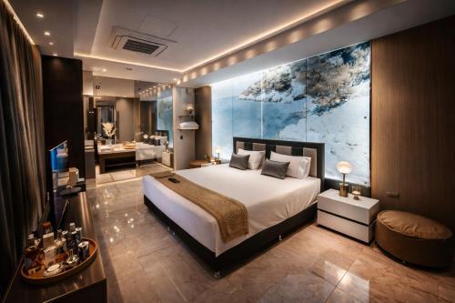 a bedroom with a large bed and a bathroom at 1Million Suites in Medellín