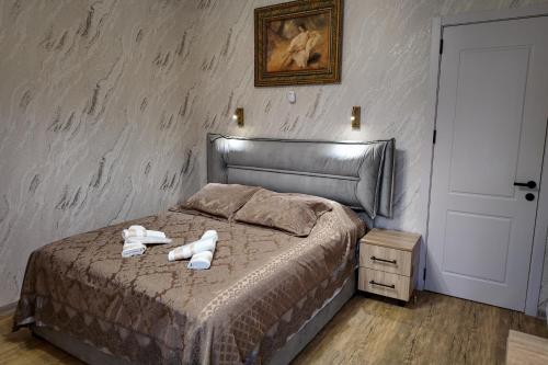 a bedroom with a bed with two towels on it at Green Corner Kutaisi in Kutaisi