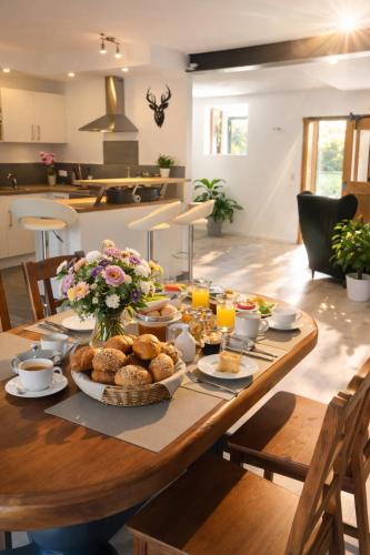 a wooden table with food on it in a kitchen at Romantik 2-6P in Mürlenbach