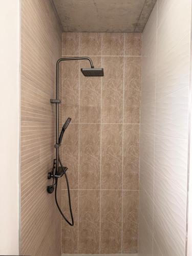 a shower with a shower head in a bathroom at Our Little Cottage in George