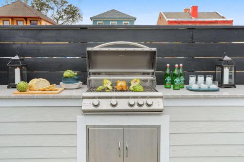 a barbecue grill with vegetables on a patio at Luxe 19BR Combo & Private Backyard with Pool in New Orleans