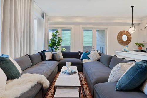 a living room with a large blue couch at Luxe 19BR Combo & Private Backyard with Pool in New Orleans