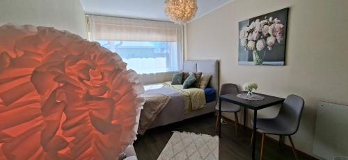 a living room with a large red flower painting on the wall at Laine Apartment in Pärnu