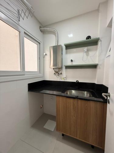 a small kitchen with a sink and a window at Smart Home em Capão da Canoa in Capão da Canoa