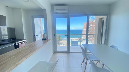 a kitchen with a table and a view of the ocean at Bella Vista in Puerto Madryn