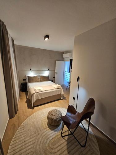 a bedroom with a bed and a chair in it at Stone house Anic in Vela Luka