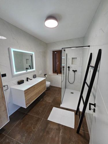 a bathroom with a shower and a sink at Stone house Anic in Vela Luka