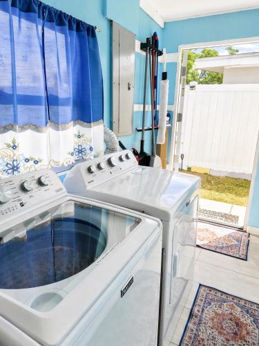 a white stove top oven sitting in a kitchen at 3BR St Pete Home Sleeps 6 Private Backyard 15 Min to Beach in St. Petersburg