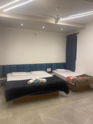 a bedroom with two beds in a room at Chavan guest house in Akalkot