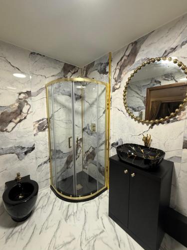 a bathroom with a shower and a sink and a mirror at Barnfields Retreat in Little Clacton