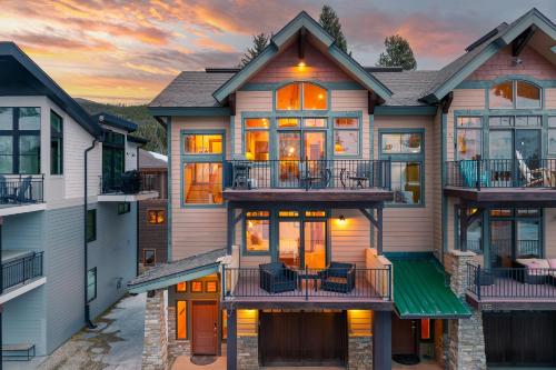 a house with balconies and a sunset in the background at Slopeside Villa 126 Next To WP Resort I Steam Shower I Great Views I Private Hot Tub in Winter Park
