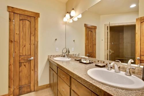 a bathroom with two sinks and a large mirror at Slopeside Villa 126 Next To WP Resort I Steam Shower I Great Views I Private Hot Tub I Activity Program in Winter Park