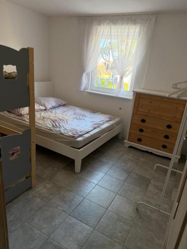 a bedroom with a bunk bed and a window at Rodzinna Przystań Arkadia in Dominice