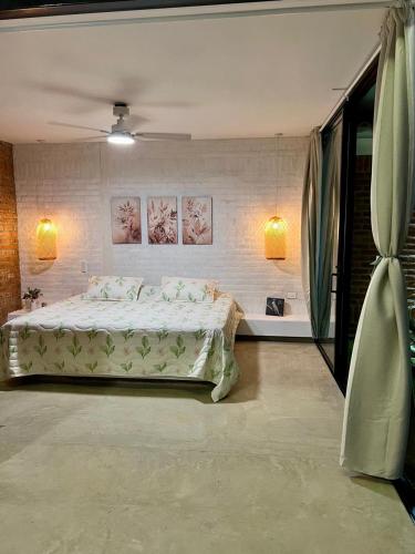 a bedroom with a bed and two paintings on the wall at Cabaña el Anhelo Calma in Ginebra